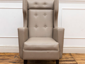 See this Winged Back Armchair in your home?The piece comes upholstered in light grey velvet with a winged back for added design and comfort.